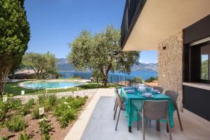 a table and chairs on a patio next to a swimming pool at Villa aMA with Pool in Pai