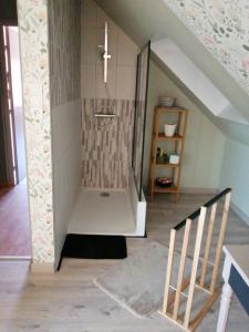 a bathroom with a shower with a cross on the wall at Eliane in Le Mans