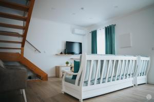 a white crib in a room with a staircase at Casa da Carreira in Almagreira