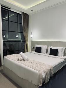 a bedroom with a large bed with white sheets at Batur Cozy Bali in Kintamani +61 photos