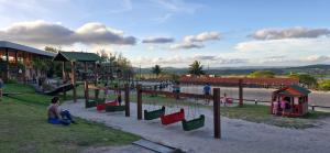 a group of children playing in a playground at Flat Divina Paz Monte Castelo in Sairé
