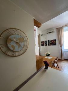 a large clock on the wall of a living room at Cozy Escape Porta Romana in Milan +12 photos