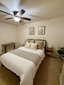 a bedroom with a bed with a ceiling fan at Lovely Provo Oasis in Provo