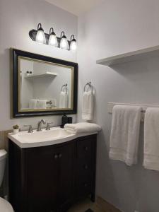 a bathroom with a sink and a mirror and towels at Lovely Provo Oasis in Provo +29 photos