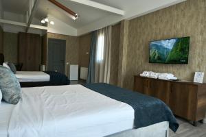 Postel nebo postele na pokoji v ubytování Hotel Saguramo Bliss