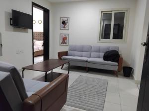 a living room with a couch and a table at MANAZEL apartment for ladies and Family only in Khor Fakkan