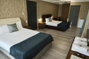 Postel nebo postele na pokoji v ubytování Hotel Saguramo Bliss