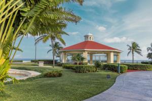 a gazebo with a red roof next to the ocean at Moon Palace Nizuc - All Inclusive in Cancún
