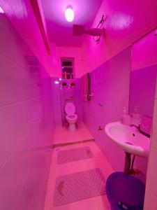 Baño de color rosa con aseo y lavamanos en The LuxeLoft, en Eldoret 34 fotos más