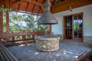 an outdoor kitchen with a large metal hood at Nad konírnou in Bystrzyca