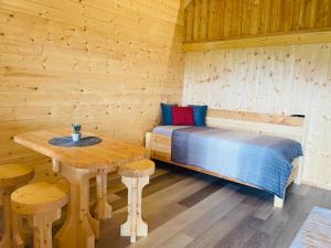 a room with a bed and a table in a cabin at Franzlhof Chalets in Stainz +31 photos