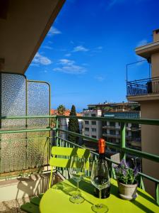 a table with two wine glasses on a balcony at La Casa di Gi&Vi in Sanremo