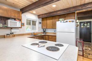 a kitchen with a white stove and a refrigerator at Coal Creek Chalet | Creek, AC, Pet Friendly in Packwood
