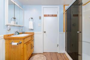 a bathroom with a sink and a shower at Coal Creek Chalet | Creek, AC, Pet Friendly in Packwood +30 photos