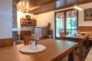 a dining room with a table with flowers on it at Nad konírnou in Bystrzyca
