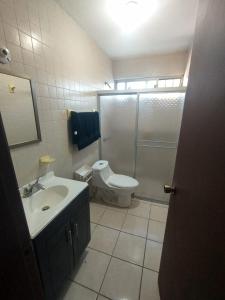a bathroom with a toilet and a sink and a shower at Depa Colima in Ciudad Obregón