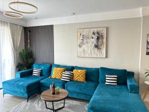 a blue couch in a living room at Homely Haven 2 Bedroom Near JKIA in Nairobi