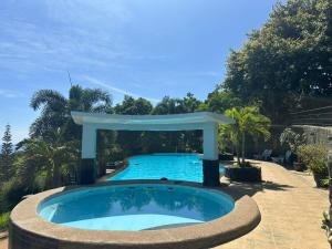 a pool with a gazebo in a yard at Bethany Hill Resort And Restaurant in Almeria