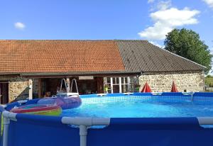 a large swimming pool with an inflatable at Cool Under Canvas in Miremont