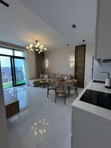 a kitchen and living room with a couch and a table at Квартира в SEEBREZE in Nardaran