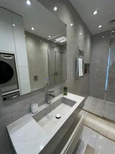 a bathroom with a sink and a large mirror at Квартира в SEEBREZE in Nardaran +12 photos