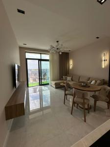 a living room with a couch and a table at Квартира в SEEBREZE in Nardaran