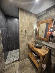 a bathroom with a sink and a shower with a mirror at Maison Médiévale LAON in Laon +9 photos
