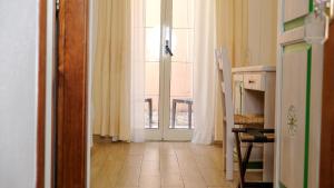 an open door to a kitchen with a window at Hotel Majore in Santa Teresa Gallura +28 photos