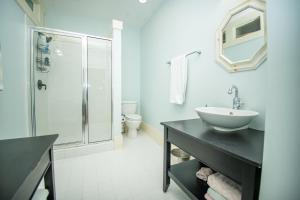 een witte badkamer met een wastafel en een douche bij Newly Listed - Spacious Condo with Private Balcony in Beaufort +14 foto's