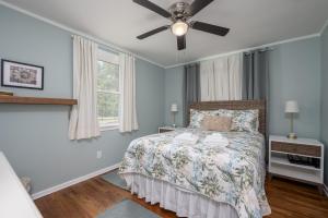 a bedroom with a bed and a ceiling fan at Cozy 3-Bedroom Retreat in Charming Beaufort, SC in Beaufort