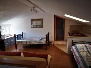 a living room with two beds and a couch at Holiday house Catela in Rakalj
