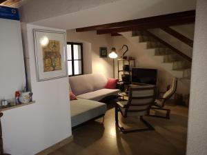 a living room with a couch and a chair at Holiday house Catela in Rakalj