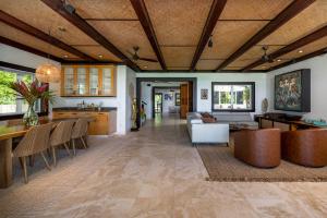a living room with a couch and a table at Hale Holawa Mana-Oceanfront Sunset Beach in Haleiwa