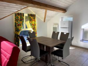 a dining room with a wooden table and chairs at Château Haut 2 lOups in Ax-les-Thermes +3 photos