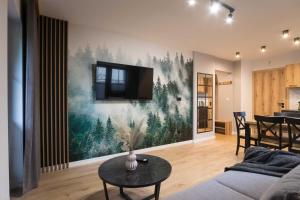 a living room with a large painting on the wall at Willa Jodełka in Zakopane