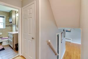 a kitchen with a white door and a refrigerator at 5 Mi to Dtwn Newark Hillside Vacation Rental in Hillside