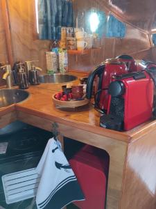 a kitchen counter with a sink and a red appliance on it at The Boat in Ovar +25 photos