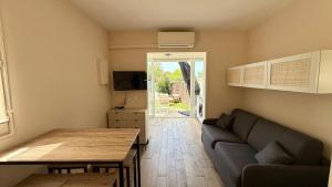a living room with a couch and a table at Studio avec jardin in Sanary-sur-Mer