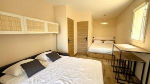 a small bedroom with two beds and a window at Studio avec jardin in Sanary-sur-Mer