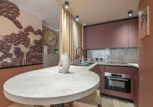 a kitchen with a table with a cat statue on it at Host Inn Sweet Croisette in Cannes +22 photos