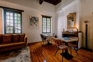 a living room with a couch and a table at La Maison du Prevot - Maison d hotes de charme au pied de la Cathedrale Sainte Cecile d Albi La Maison du Prevot - Charming Guesthouse at Foot of Albi Cathedral in Albi