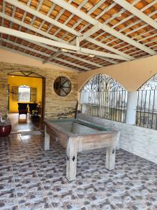 a pool table in a room with windows at Casarão Mosqueiro Castle in Belém +16 photos
