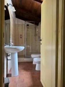 a bathroom with two toilets and a sink and a shower at Malga Filippi 1241 in Polino