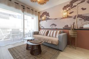 a living room with a couch and a table at Host Inn Sweet Croisette in Cannes