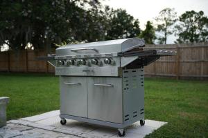 a grill sitting on a patio in a yard at Zephyrhills House for 4 people WiFi BBQ Mini Golf in Zephyrhills