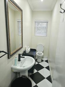 a bathroom with a sink and a toilet and a mirror at The Rose Cottage in Hilton