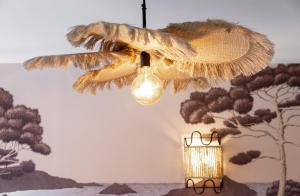 a chandelier hanging from a wall with a painting at Host Inn Sweet Croisette in Cannes