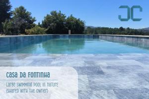 a large pool of water with a sign on it at Casa da Fontinha - Swimming Pool & Free Parking 