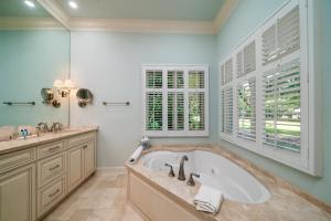 a large bathroom with a tub and a window at 2386 Golf Oak Park in Seabrook Island +32 photos