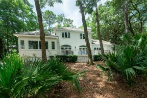 a white house with trees in front of it at 2386 Golf Oak Park in Seabrook Island